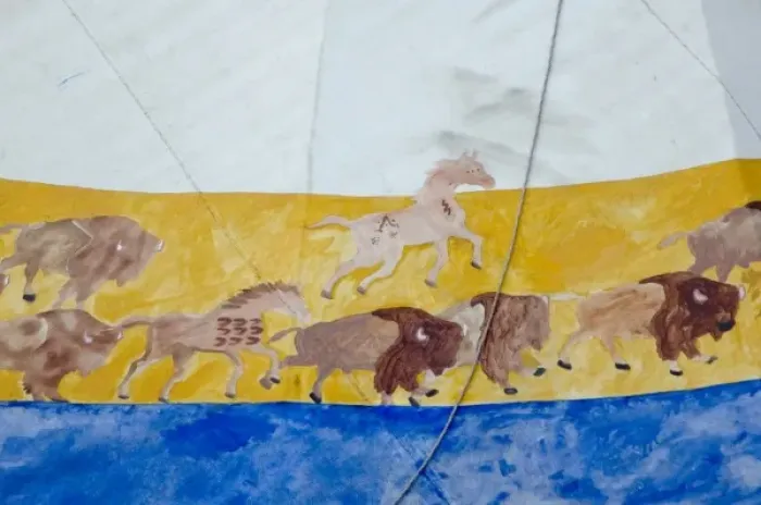 Framed Print : Painted buffalo herd and horses decorate a Lakota Sioux tepee