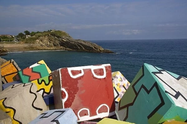 Painted cement blocks in the harbor at Llanes, Spain