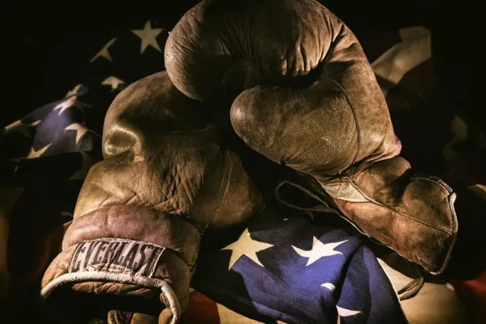 Framed Print : A pair of vintage boxing gloves laying on a flag carefully painted with light Framed Print : A pair of vintage boxing gloves laying on a flag carefully painted with light