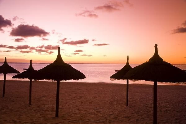 Palapa style beach huts at sunrise, Belle Mare Public Beach, Southeast Mauritius, Africa