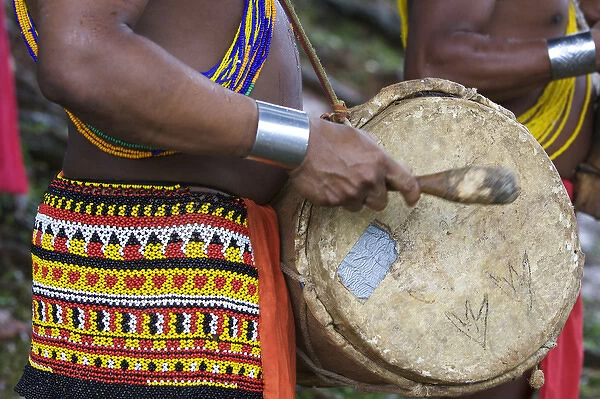 Panama. A close up of a young Embra indian man playing the drums