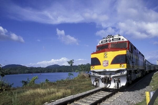 Panama, Gamboa, Panama Canal Locomotive races down tracks along Panama Canal in early