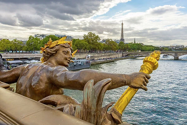 Paris. Nymphes de la Seine statue on Pont Alexandre III, along River Seine. Distant Eiffel Tower