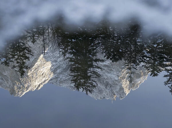 Peak of Zugspitze (2962m), germanys highest mountain, during winter is reflected in lake Eibsee