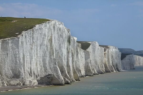 People atop Seven Sisters Chalk Cliffs, seen from Cuckmere Haven, near Seaford, East Sussex