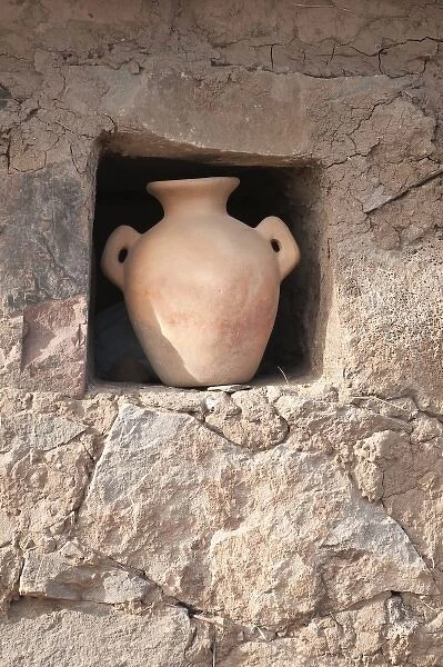 Peru, Atuncolla. Quechua stone house and ceramic water jar