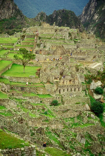Peru: Mach Picchu, Incan ruins, hikers and tourists walking around Incan ruins, November