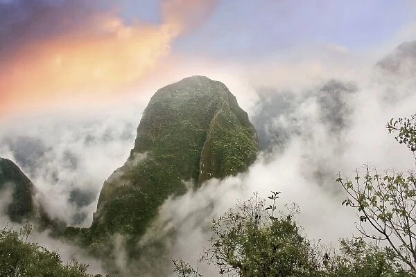 Peru, Machu Picchu, the ancient lost city of the Inca shrouded in mist and clouds at sunrise