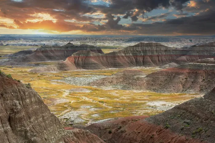 Framed Print : The pink striped peaks or hoodoos are layered with a grass valley, at sunset Framed Print : The pink striped peaks or hoodoos are layered with a grass valley, at sunset
