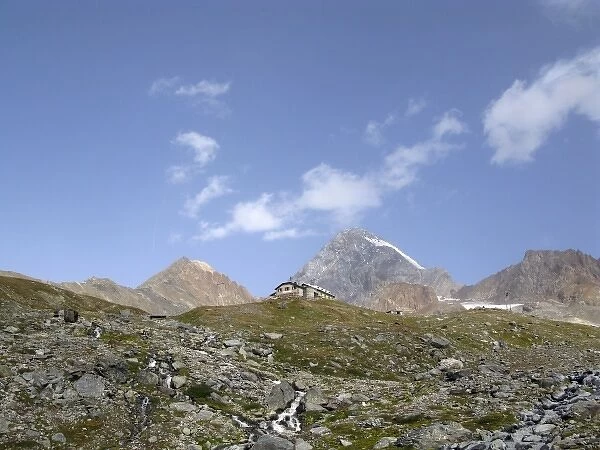 Pizzini hut (2706 m) in the upper Sondrio province, Italy. In the background, the