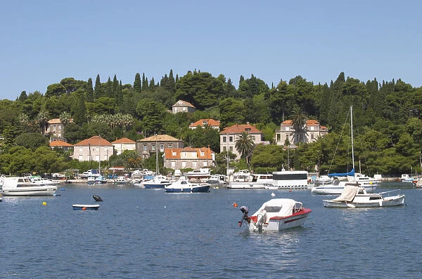 Pleasure boats moored on buoys and along the key, villas along the coast. Luka Gruz harbour