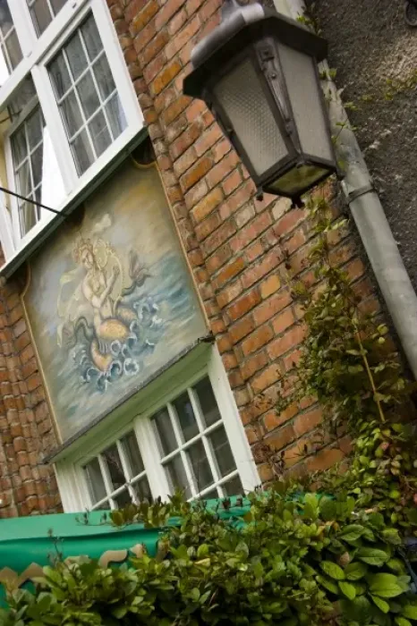 Framed Print : Poland, Gdansk. Detail of lamp post and painting on building in Old Town