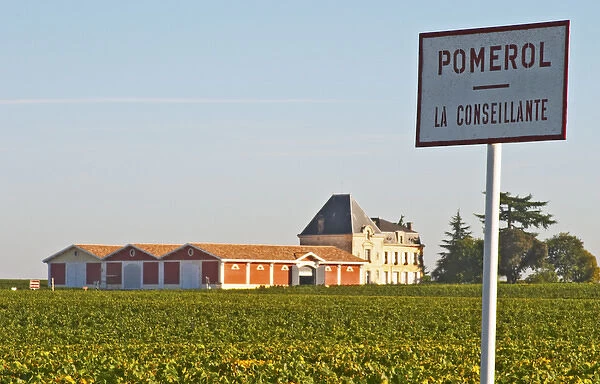 Pomerol vineyards - A sign with La Conseillante, with the chateau Evangile with winery