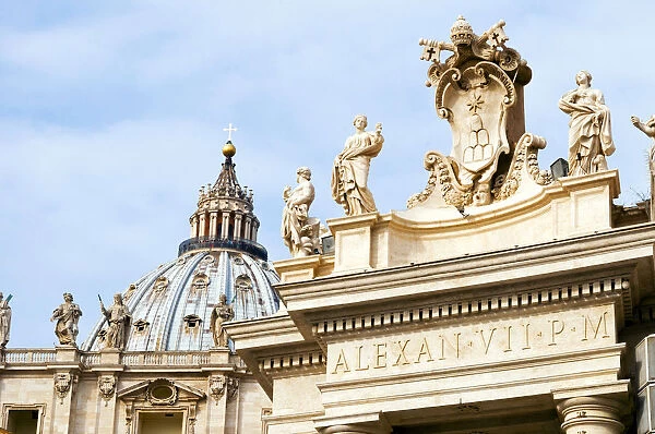 Popes insignia between two statues of saints on the Berninis 17th century colonnade