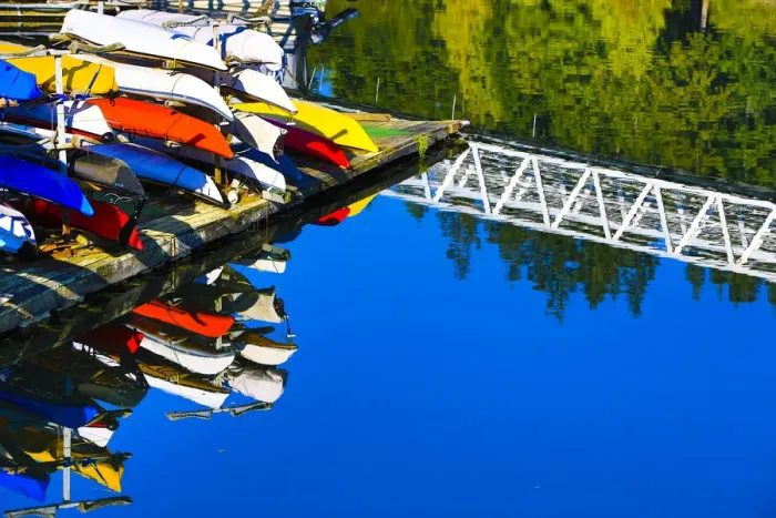 Framed Print : Port Ludlow Marina, Washington. Colorful kayaks and a white bridge on the dock