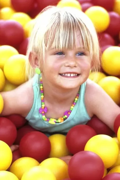 Framed Print : Portrait of a young girl, smiling, having fun on the McDonalds balls playground