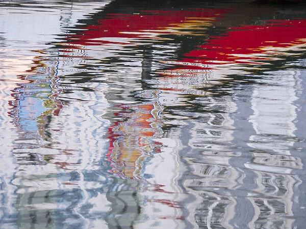 Portugal, Aveiro. Reflections of traditional and colorful salt boats, called Moliceiro