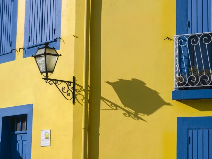 Framed Print : Portugal, Aveiro. Shadow of street lantern on colorful yellow building with bright blue Framed Print : Portugal, Aveiro. Shadow of street lantern on colorful yellow building with bright blue