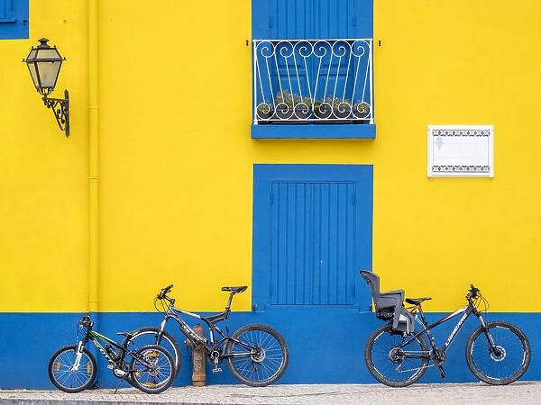 Portugal, Aveiro. Yellow house with blue shutters, windows and doors in the city of Aveiro