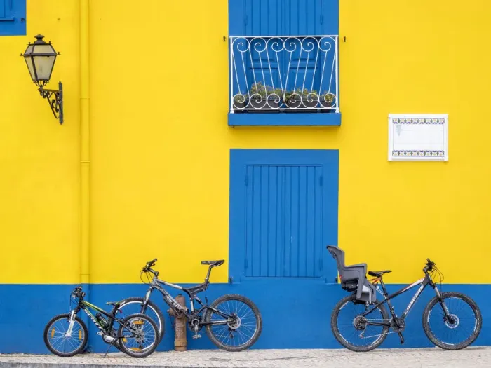Framed Print : Portugal, Aveiro. Yellow house with blue shutters, windows and doors in the city of Aveiro
