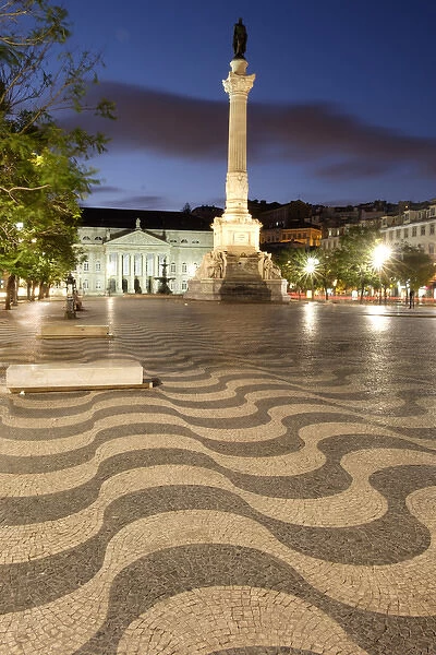 Portugal, Lisbon. Pedro IV Statue looms over Rossio Square at night