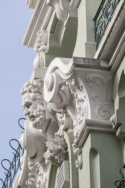 Portugal, Lisbon. Pombaline district, stone faces and animal heads adorn pastel colored