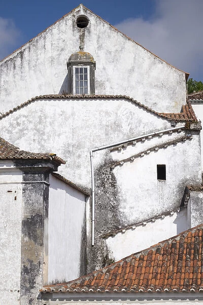 Portugal, Obidos. Ancient, red, terra cotta tiled roof tops, lines