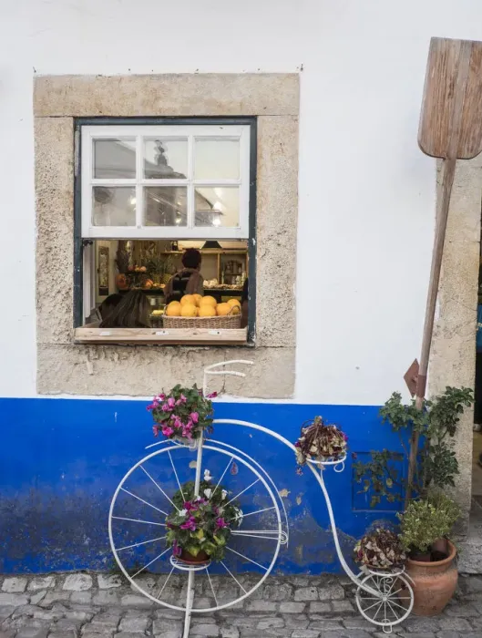 Framed Print : Portugal, Obidos. Cute bicycle planter in front of a bakery in the walled city of Obidos