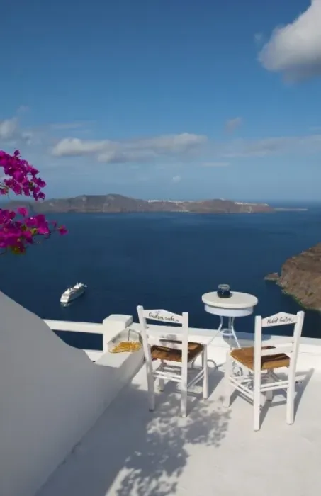 Framed Print : Postcard scene of two lonely chairs on terrace with table ready for tourists in Santorini Framed Print : Postcard scene of two lonely chairs on terrace with table ready for tourists in Santorini