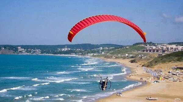 Powered paraglider flying over Gumusdere beach on the Black Sea coast of Istanbul