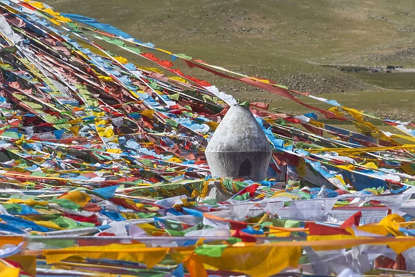 Prayer flags with juniper incense burner on Tibetan Plateau, Namtso (Lake Nam), Tibet