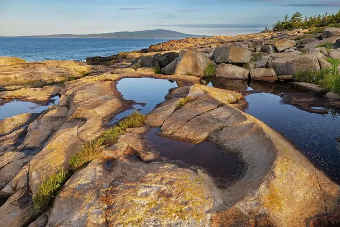 Framed Print : Puddles reflect in the pink granite at Schoodic Point in Acadia National Park, Maine, USA