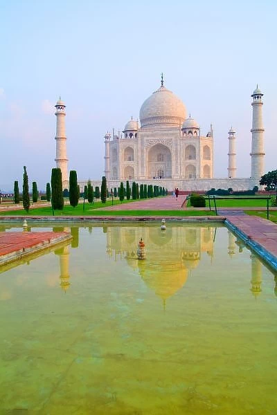 The quiet peaceful World Famous Taj Mahal at sunrise with reflrection one of the wonders of the world in Agra