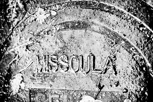 Rain covered manhole cover in Missoula, Montana