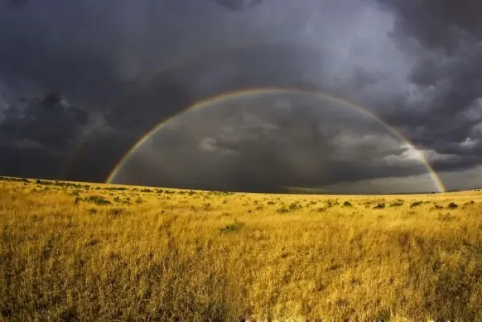 Framed Print : A rainbow appearing through a misty after noon in the Msai Mara Kenya. (RF)