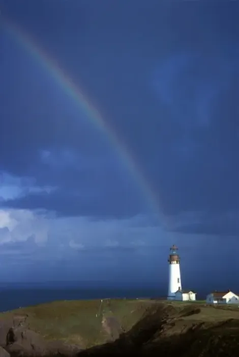 Framed Print : Rainbow drops down onto Yakina Bay lighthouse on the coast near Newport, Oregon