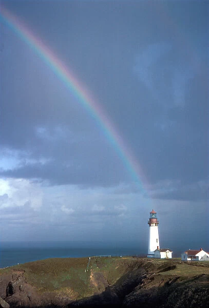 A rainbow hangs above the Yaquina Lighthouse, on Yaquina Head, above the Pacific Ocean near Newport