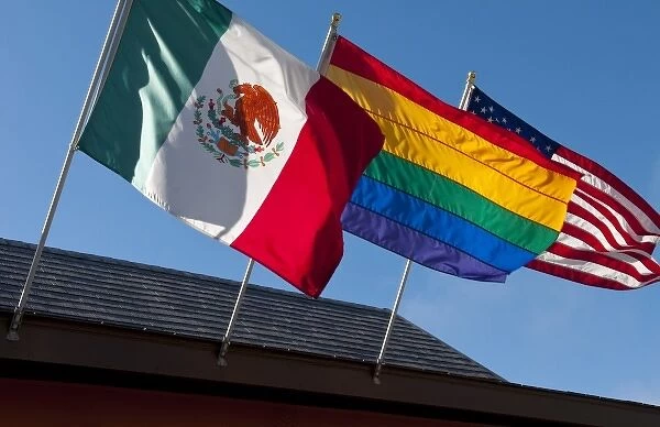 Rainbow, Mexican, and American flags on display in Castro district of San Francisco