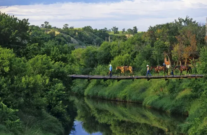 Framed Print : Ranchers lead Horses over Knife River in Golden Valley North Dakota
