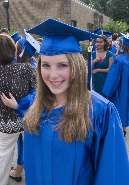 Randolph, New Jersey. Model released 8th grade girl at graduation ceremony in graduation robe
