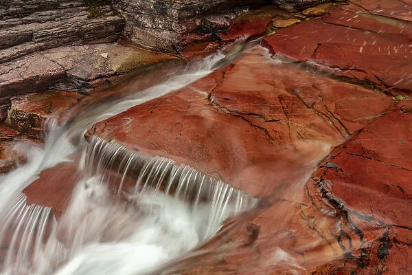 Red rocks at the bottom of Virginia Creek in Glacier National Park, Montana, USA