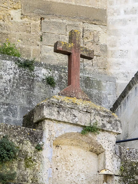 Red stone cross in the old town of Matera