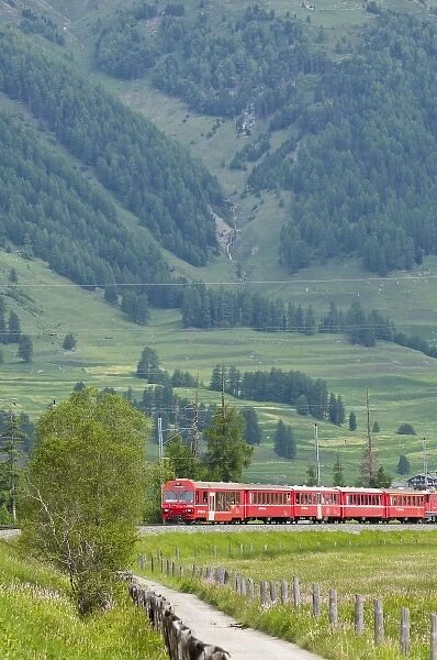 Red train crossing Swiss countryside