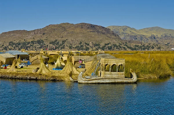 Reed boats of the Uros Islands (Islas Uros) ply the calm waters of lake Titicaca, Peru