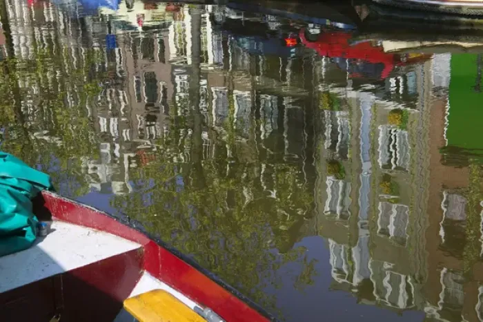 Framed Print : Reflection of boat and houses in water along canal belt, Amsterdam, Netherlands Framed Print : Reflection of boat and houses in water along canal belt, Amsterdam, Netherlands