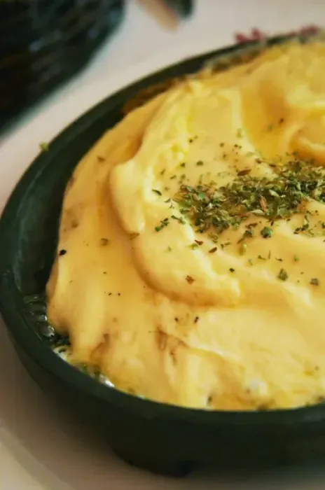 Framed Print : Regional dish of melted cheese on an iron plate with herbs, in the restaurant El Palenque