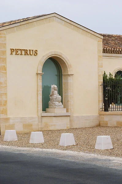 Renovated Chateau Petrus with a sign with the name in gold and a stone statue of