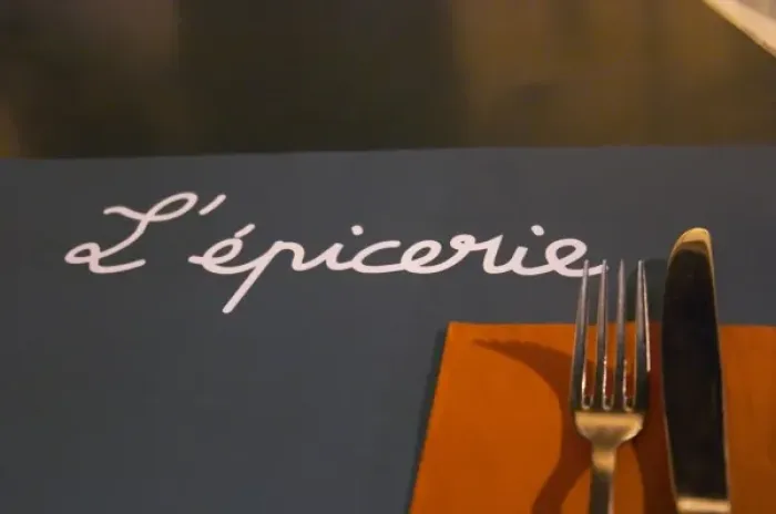 Framed Print : The restaurant l Epicerie in Avignon. Detail of table mat and knife fork and napkin