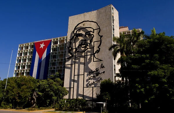 Revolution Square in Havana Cuba with large neon artwork of Che on wall and Cuban flag
