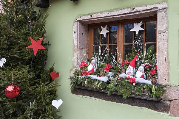 Riquewihr, France. Village established in the 1400s in the Alsace Region. Window decorated with Christmas ornaments